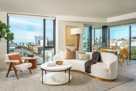 a living room with a white couch and a large window